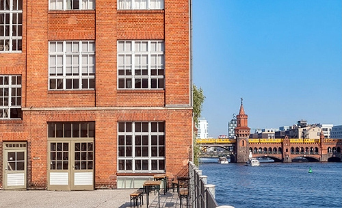 Exterior view of a commercial building on the Spree, Oberbaumbrücke in the background