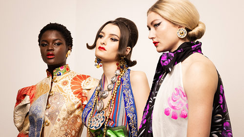 Three models in colorful dresses at Berlin Fashion Week